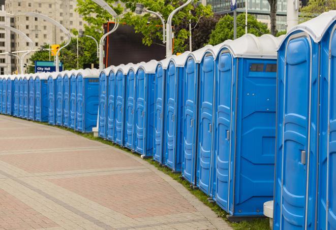 a row of portable restrooms set up for a large athletic event, allowing participants and spectators to easily take care of their needs in Carlisle, MA